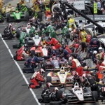 Teams, including those of Australia's Will Power (12) and Brazil's Helio Castroneves (3), pit during a yellow flag on lap 58 of the Indianapolis 500 auto race at Indianapolis Motor Speedway in Indianapolis, Sunday, May 26, 2013. (AP Photo/AJ Mast)