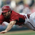 Arizona Diamondbacks' Adam Eaton dives back safely to first base after a fly out to centerfield by Martin Prado during the third inning of an exhibition spring training baseball game against the Colorado Rockies on Sunday, Feb. 24, 2013 in Scottsdale. Ariz. (AP Photo/Marcio Jose Sanchez)