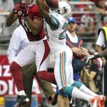 Miami Dolphins cornerback Sean Smith breaks up a pass intended for Arizona Cardinals wide receiver Larry Fitzgerald (11) during the first half of an NFL football game, Sunday, Sept. 30, 2012, in Glendale, Ariz. (AP Photo/Paul Connors)