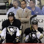 Pittsburgh Penguins coach Dan Bylsma stands behind James Neal (18) and Jussi Jokinen (36) during the third period of Game 2 of the NHL hockey Stanley Cup playoffs Eastern Conference finals against the Boston Bruins, in Pittsburgh on Monday, June 3, 2013. The Bruins won 6-1. (AP Photo/Gene J. Puskar)