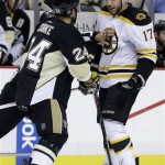 Pittsburgh Penguins' Matt Cooke (24) and Boston Bruins' Milan Lucic (17) are separated by a linesman during the second period of Game 2 of the NHL hockey Stanley Cup playoffs Eastern Conference finals, in Pittsburgh on Monday, June 3, 2013. (AP Photo/Gene J. Puskar)