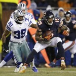 Chicago Bears wide receiver Brandon Marshall (15) runs past Dallas Cowboys cornerback Brandon Carr (39) after making a catch during the first half of an NFL football game, Monday, Dec. 9, 2013, in Chicago. (AP Photo/Nam Y. Huh)