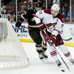 Phoenix Coyotes center Martin Hanzal (11), from the Czech Republic takes the puck around the net as Anaheim Ducks defenseman Cam Fowler follows during the first period of an NHL hockey game, Sunday, Oct. 23, 2011, in Anaheim, Calif. (AP Photo/Bret Hartman)