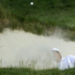 Michael Kim hits out of a bunker on the 17th hole during the third round of the U.S. Open golf tournament at Merion Golf Club, Saturday, June 15, 2013, in Ardmore, Pa. (AP Photo/Julio Cortez)
