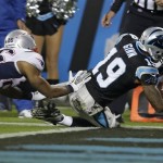 Carolina Panthers' Ted Ginn (19) falls into the end zone for a touchdown as New England Patriots' Logan Ryan (26) defends during the second half of an NFL football game in Charlotte, N.C., Monday, Nov. 18, 2013. (AP Photo/Gerry Broome)