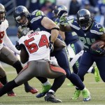  Seattle Seahawks running back Marshawn Lynch, right, rushes as Tampa Bay Buccaneers' Lavonte David (54) is blocked by Seattle Seahawks tight end Zach Miller (86) in the first half of an NFL football game Sunday, Nov. 3, 2013, in Seattle. (AP Photo/Elaine Thompson)