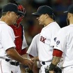 Boston Red Sox's Jake Peavy, center, hands the ball to manager John Farrell (53) as he is taken out of an interleague baseball game in the eighth inning against the Arizona Diamondbacks in Boston, Saturday, Aug. 3, 2013. (AP Photo/Michael Dwyer)
