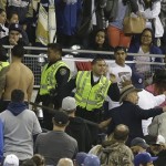 San Diego police with the help of Petco Park security make arrest while breaking up a fight in the stands during baseball game between the San Diego Padres and the Los Angeles Dodgers in San Diego, Thursday, April 11, 2013. The Padres and Dodgers engaged in a brawl in the sixth inning before fights broke out in the stands. (AP Photo/Lenny Ignelzi)