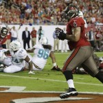 Tampa Bay Buccaneers tackle Donald Penn, right, catches a 1-yard pass for a touchdown against the Miami Dolphins during the first half of an NFL football game in Tampa, Fla., Monday, Nov. 11, 2013.(AP Photo/John Raoux)