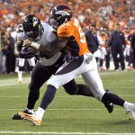 Baltimore Ravens running back Vonta Leach (44) scores a touchdown as Denver Broncos outside linebacker Wesley Woodyard (52) tries to stop him during the first half of an NFL football game, Thursday, Sept. 5, 2013, in Denver. (AP Photo/Jack Dempsey)