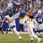 Indianapolis Colts wide receiver T.Y. Hilton (13) makes a catch as Kansas City Chiefs cornerback Dunta Robinson (21) moves in to defend during the first half of an NFL wild-card playoff football game Saturday, Jan. 4, 2014, in Indianapolis. (AP Photo/Michael Conroy)