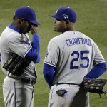 Los Angeles Dodgers' Yasiel Puig and Carl Crawford pause during a pitching change during the fifth inning of Game 6 of the National League baseball championship series against the St. Louis Cardinals, Friday, Oct. 18, 2013, in St. Louis. (AP Photo/Chris Carlson)