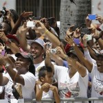 NBA champion Miami Heat fans cheer on the Heat players during the parade in their honor in Miami, Monday, June 24, 2013. (AP Photo/Alan Diaz)
