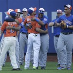 Players representing the American, in blue, and National Leagues embrace during batting practice for the MLB All-Star baseball game, on Monday, July 15, 2013 in New York. (AP Photo/Matt Slocum)