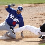 Los Angeles Dodgers' Andre Ethier, left, slides safely into second base as Chicago White Sox shortstop Alexei Ramirez, right, tumbles backwards and cannot handle the throw on a double hit by Ethier in the second inning of a spring training baseball game Monday, March 5, 2012, in Glendale, Ariz. (AP Photo/Paul Connors)