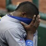 Los Angeles Dodgers' Yasiel Puig covers his eyes in the dugout during the seventh inning of Game 2 of the National League baseball championship series against the St. Louis Cardinals Saturday, Oct. 12, 2013, in St. Louis. (AP Photo/David J. Phillip)