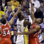 Indiana Pacers center Roy Hibbert (55) shoots between Atlanta Hawks guard Devin Harris, left, and center Al Horford in the first half of Game 2 of a first-round NBA basketball playoff series in Indianapolis, Wednesday, April 24, 2013. (AP Photo/Michael Conroy)