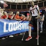 Fans cheer as Louisville's Kevin Ware heads to the court before the NCAA Final Four tournament college basketball semifinal game against Wichita State, Saturday, April 6, 2013, in Atlanta. (AP Photo/John Bazemore)
