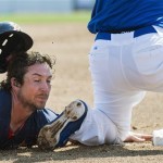 Houston Astros' Brett Wallace slides into third base after being tagged out by Toronto Blue Jays' Brett Lawrie during the third inning of a spring training baseball game in Dunedin, Fla., on Wednesday, Feb. 27, 2013. (AP Photo/The Canadian Press, Nathan Denette)