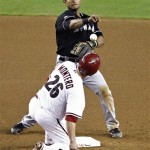 Miami Marlins' Donovan Solano forces out Arizona Diamondbacks' Miguel Montero while trying to turn a double play during the seventh inning in the first baseball game of a doubleheader, Wednesday, Aug. 22, 2012, in Phoenix. (AP Photo/Matt York)