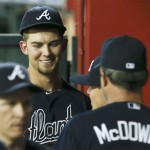 Atlanta Braves' Mike Minor, back left, smiles as he talks with pitching coach Roger McDowell in the dugout during the seventh inning of a baseball game against the Arizona Diamondbacks, on Monday, May 13, 2013, in Phoenix. (AP Photo/Ross D. Franklin)