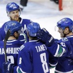 Vancouver Canucks' Henrik Sedin (33) celebrates his goal against the Phoenix Coyotes with teammates Daniel Sedin (22), Dan Hamhuis (2) and Christopher Tanev (8) during second period NHL hockey action in Vancouver, British Columbia, on Friday Dec. 6, 2013. (AP Photo/The Canadian Press, Ben Nelms)
