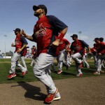 St. Louis Cardinals catcher Yadier Molina, front, jogs with teammates before an exhibition spring training baseball game against the New York Mets, Wednesday, Feb. 27, 2013, in Port St. Lucie, Fla. (AP Photo/Julio Cortez)