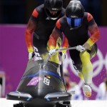 The team from Germany GER-1, piloted by Francesco Friedrich and brakeman Jannis Baecker, start their third run during the men's two-man bobsled competition at the 2014 Winter Olympics, Monday, Feb. 17, 2014, in Krasnaya Polyana, Russia. (AP Photo/Michael Sohn)