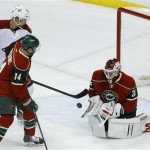  Minnesota Wild goalie Niklas Backstrom (32), of Finland, deflects a shot by Phoenix Coyotes left wing Rob Klinkhammer (36) as Wild right wing Justin Fontaine (14) defends during the first period of an NHL hockey game in St. Paul, Minn., Wednesday, Nov. 27, 2013. (AP Photo/Ann Heisenfelt)