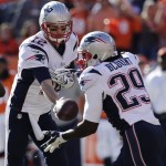 New England Patriots quarterback Tom Brady (12) hands of to New England Patriots running back LeGarrette Blount (29) during the first half of the AFC Championship NFL playoff football game against the Denver Broncos in Denver, Sunday, Jan. 19, 2014. (AP Photo/Julie Jacobson)