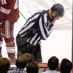  Linesman Scott Driscoll (68) checks his jaw after being hit with the puck during the second period of an NHL hockey game between the Phoenix Coyotes and the Buffalo Sabres, Thursday, Jan. 30, 2014, in Glendale, Ariz. (AP Photo)