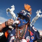 Denver Broncos fan Chuck DeVorss, who goes by the nickname "Broncinator," bites a doll dressed as New England Patriots quarterback Tom Brady before heading into the stadium to watch the AFC Championship NFL football game in Denver, Sunday, Jan. 19, 2014. (AP Photo/David Zalubowski)