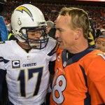 San Diego Chargers quarterback Philip Rivers, left, and Denver Broncos quarterback Peyton Manning greet each other at midfield after the Broncos beat the Chargers 24-17 in an NFL AFC division playoff football game, Sunday, Jan. 12, 2014, in Denver. (AP Photo/Jack Dempsey)