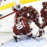 Detroit Red Wings' Todd Bertuzzi, top left, 
scores a goal as he gets the puck past 
Phoenix Coyotes' Ilya Bryzgalov (30), of 
Russia, Eric Belanger (20) and David Schlemko 
(6) during the third period in Game 4 of a 
first-round NHL hockey Stanley Cup playoffs 
series Wednesday, April 20, 2011, in 
Glendale, Ariz. The Red Wings defeated the 
Coyotes 6-3 and earned a 4-0 sweep in the 
series. (AP Photo/Ross D. Franklin)