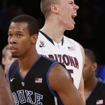  Arizona's Kaleb Tarczewski, behind, reacts after a 3-point basket by teammate Nick Johnson, as Duke's Rodney Hood (5) passes by during the second half of an NCAA college basketball game in the championship of the NIT Season Tip-off tournament Friday, Nov. 29, 2013, in New York. Arizona won 72-66. (AP Photo/Jason DeCrow)