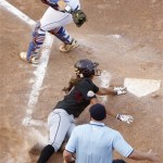 Home plate umpire Paul Edds, right, watches the play as Arizona State's Alix Johnson, center, slides safely into home plate, avoiding the tag of Florida catcher Tiffany DeFelice, left, in the second inning of a Women's College World Series championship series game in Oklahoma City, Tuesday, June 7, 2011. (AP Photo/Sue Ogrocki)