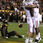 Arizona's David Douglas (85) celebrates a touchdown by Ka'Deem Carey, right, as Arizona State's Vontaze Burfict (7) sits on the ground during the first quarter of an NCAA college football game, Saturday, Nov. 19, 2011, in Tempe, Ariz. (AP Photo/Ross D. Franklin)