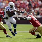 Indianapolis Colts running back Ahmad Bradshaw (44) carries the ball past San Francisco 49ers safety Donte Whitner (31) and linebacker Aldon Smith (99) in the first half of an NFL football game in San Francisco, Sunday, Sept. 22, 2013. (AP Photo/Marcio Jose Sanchez)