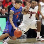 Florida's Scottie Wilbekin (5) drives pass the defense of Arizona's Mark Lyons (2) during the first half of an NCAA college basketball game at McKale Center in Tucson, Ariz.,Saturday, Dec. 15, 2012. (AP Photo/John Miller)
