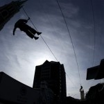 People ride the zip line at the Super Bowl Village in Indianapolis, Friday Feb. 3, 2012. The New England Patriots are scheduled to face the New York Giants in NFL football's Super Bowl XLVI in Indianapolis on Feb 5. (AP Photo/Elise Amendola)