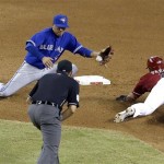 Arizona Diamondbacks' Gerardo Parra, right, steals second base as Toronto Blue Jays' Ryan Goins, left, is unable to come up with the ball while umpire Mark Ripperger watches during the seventh inning of a baseball game, Wednesday, Sept. 4, 2013, in Phoenix. (AP Photo/Ross D. Franklin)