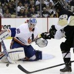 Pittsburgh Penguins' Kris Letang (58) can't get a shot past New York Islanders goalie Kevin Poulin (60) during the second period of Game 1 of an NHL hockey Stanley Cup first-round playoff series, Wednesday, May 1, 2013, in Pittsburgh. (AP Photo/Gene J. Puskar)
