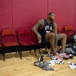 DeMarcus Cousins of the Sacramento Kings changes his shoes after a USA Basketball mini camp practice, Monday, July 22, 2013, in Las Vegas. Twenty-eight of the best young players in the country are in Las Vegas for four days of workouts that essentially mark the kickoff of 2016 Olympic preparations. (AP Photo/Julie Jacobson)