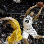  Michigan State guard Denzel Valentine (45) grabs a rebound over Valparaiso guard Matt Kenney (23) in the first half of a second-round game of the NCAA college basketball tournament in Auburn Hills, Mich., Thursday March 21, 2013. (AP Photo/Paul Sancya)