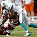 Arizona Cardinals running back Ryan Williams, center, is tackled by Miami Dolphins free safety Reshad Jones, right, during the first half of an NFL football game, Sunday, Sept. 30, 2012, in Glendale, Ariz. (AP Photo/Matt York)