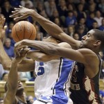 Duke's Rodney Hood, center, is fouled by Florida State's Robert Gilchrist, right, during the second half of an NCAA college basketball game in Durham, N.C., Saturday, Jan. 25, 2014. Duke won 78-56. (AP Photo/Gerry Broome)