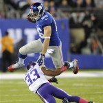 New York Giants tight end Bear Pascoe (86) leaps over Minnesota Vikings' Jamarca Sanford (33) during the first half of an NFL football game Monday, Oct. 21, 2013 in East Rutherford, N.J. (AP Photo/Bill Kostroun)