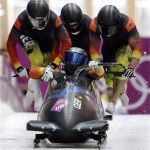 The team from Germany GER-2, with Francesco Friedrich, Jannis Baecker, Gregor Bermbach and Thorsten Margis, start their third run during the men's four-man bobsled competition final at the 2014 Winter Olympics, Sunday, Feb. 23, 2014, in Krasnaya Polyana, Russia. (AP Photo/Natacha Pisarenko)