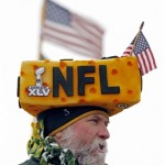  A Green Bay Packers wears a cheesehead as fans arrive at Lambeau Field before an NFL wild-card playoff football game between the Green Bay Packers and the San Francisco 49ers, Sunday, Jan. 5, 2014, in Green Bay, Wis. (AP Photo/Mike Roemer)
