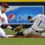 Arizona Diamondbacks' Cliff Pennington forces out Colorado Rockies' Eric Young Jr. (1) on a double play during the first inning of a baseball game, Thursday, April 25, 2013, in Phoenix. (AP Photo/Matt York)